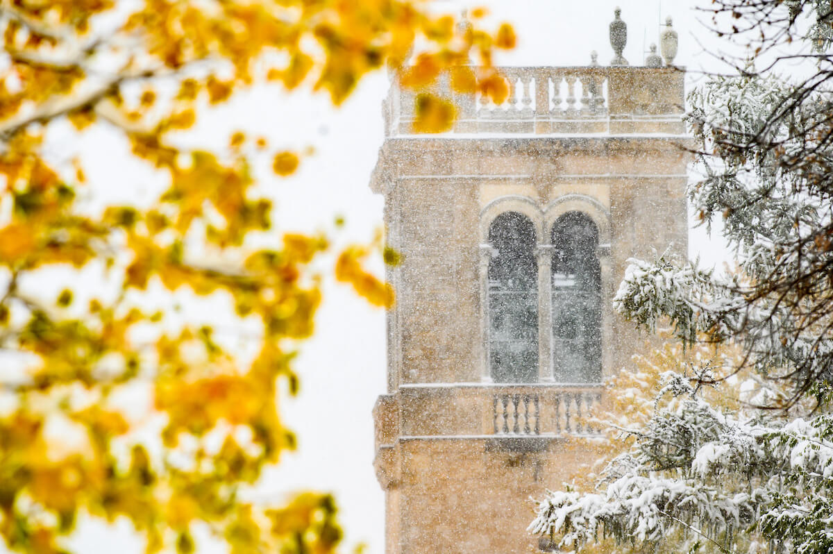 The Carillon Tower is pictured through colorful fall foliage during an early-season snowstorm.